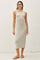 woman wearing a light gray ribbed tank dress that falls below the knee, paired with flat sandals and glasses