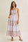 woman wearing a lavender floral maxi dress with adjustable straps and tiered ruffle detail