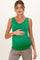 woman wearing a green sleeveless maternity top and holding her baby bump