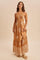 woman wearing a brown halter neck maxi dress with white tribal print and a tiered skirt