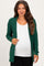 woman wearing a dark green ribbed maternity cardigan over a white shirt, showing her baby bump