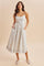 woman wearing a floral print maxi dress with thin straps and pockets, styled with espadrille flats