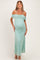 woman wearing a mint green lace off-the-shoulder maternity dress, showing her baby bump