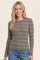 woman wearing a gray ribbed long sleeve top with white stripes and smiling