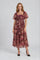 woman wearing a floral maxi dress with puff sleeves and a tiered skirt