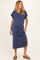 woman wearing a navy blue ribbed maternity maxi dress with rolled sleeves and a side slit