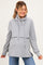woman wearing a gray maternity pullover hoodie with a cowl neck and layered design, smiling and showing her baby bump