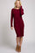 woman wearing a burgundy long sleeve fitted dress and tan heeled ankle boots