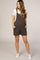 woman wearing a brown maternity overall romper with pockets and a white t-shirt underneath