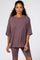 woman wearing a mauve oversized short sleeve t-shirt with a chest pocket paired with matching biker shorts