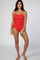 woman wearing a red ribbed one-piece swimsuit with adjustable side ties
