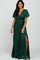 woman wearing a dark green wrap maxi dress with short puff sleeves and a side slit