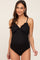 woman wearing a black maternity swimsuit with ruffle detailing and gathered sides, showing a baby bump