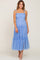 woman wearing a light blue smocked maternity midi dress with tiered tulle skirt and tie straps