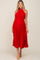 woman wearing a red pleated maternity dress with a halter neck and tied waist, showcasing her baby bump