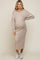 woman wearing a beige hooded maternity sweater dress with long sleeves and a visible baby bump