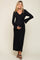 woman wearing a black ribbed maternity dress with a v-neck and tie waist, holding her baby bump