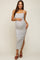 woman wearing a striped maternity maxi dress with a side slit, holding her baby bump