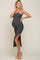 woman wearing a black and white striped maternity dress with a side slit and a visible baby bump