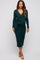 woman wearing a dark green long sleeve maternity dress with a tie detail at the waist and a visible baby bump