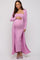 woman wearing a pink ribbed maternity dress with a fitted silhouette and long cardigan, displaying her baby bump