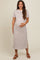 woman wearing a brown and white striped maternity dress with short sleeves and a side slit, holding her baby bump