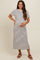 woman wearing a striped maternity maxi dress with short sleeves and side slits, showcasing her baby bump
