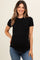 woman wearing a black short sleeve maternity top with a rounded hem and a visible baby bump