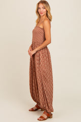 woman wearing a brown patterned maxi dress with a smocked bodice and relaxed fit, paired with brown sandals