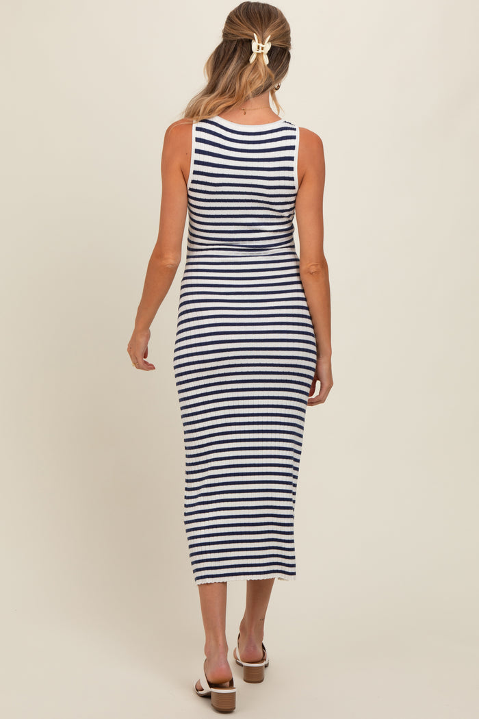 woman wearing a navy and white striped maternity maxi dress, showing the back view and extending to mid-calf