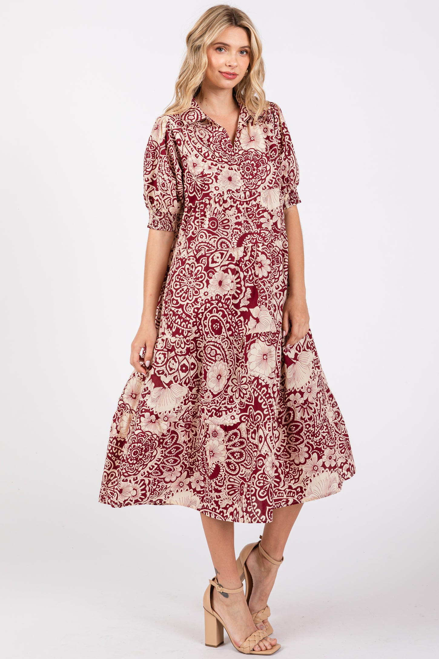 woman wearing a burgundy and cream floral print midi dress with puff sleeves and a button-up front