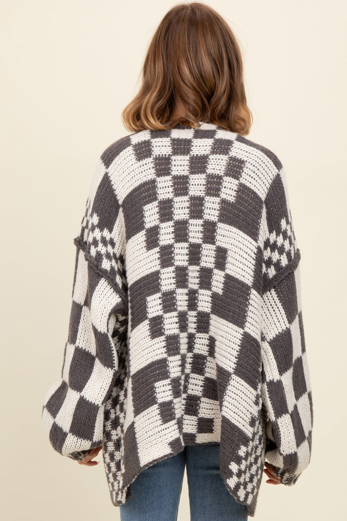 woman wearing a gray and white checkered oversized sweater from the back with loose sleeves