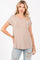 woman wearing a light taupe short sleeve top paired with distressed light blue jeans