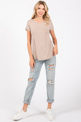 woman wearing a taupe short sleeve t-shirt with relaxed fit and light blue distressed jeans