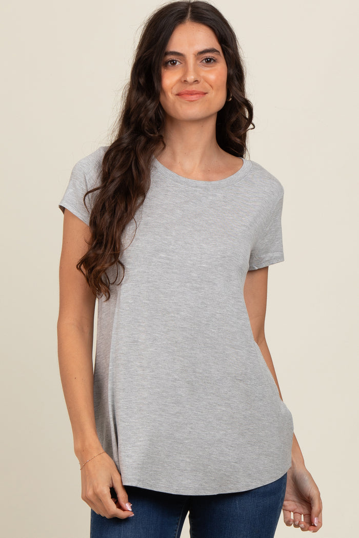woman wearing a grey short sleeve t-shirt with a relaxed fit and round neckline