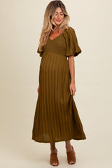 woman wearing an olive green maternity maxi dress with short puff sleeves and a fitted bodice, showcasing her baby bump