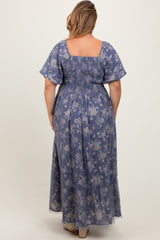 plus size woman wearing a blue floral smocked back maternity maxi dress with ruffled hem