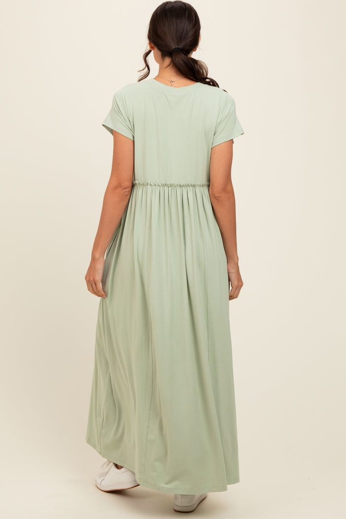 woman wearing a mint green maxi dress with a cinched waist and short sleeves, viewed from the back