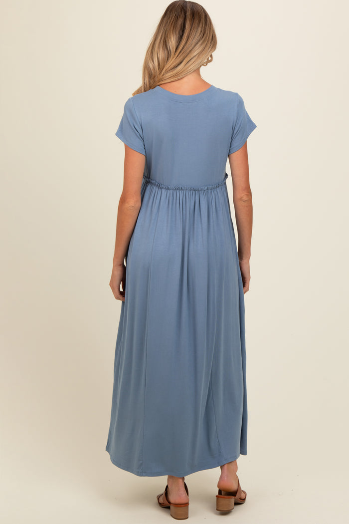 woman wearing a light blue maternity maxi dress with a gathered waist from the back