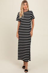 woman wearing a black and white striped maxi dress with short sleeves and side slits