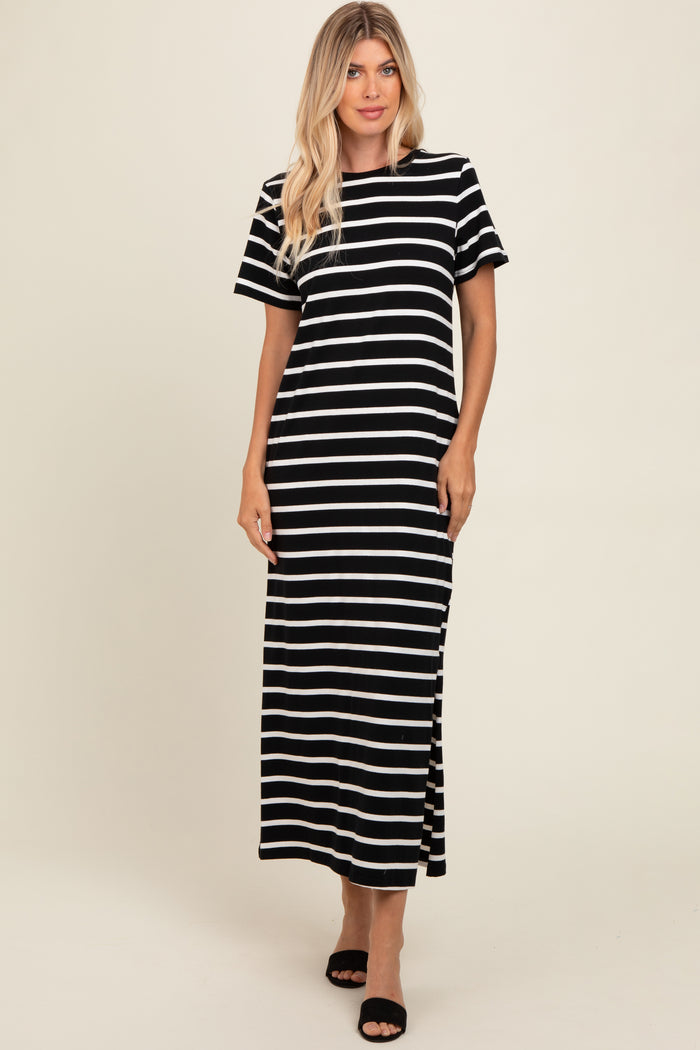woman wearing a black and white striped maxi dress with short sleeves and side slits