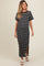 woman wearing a black and white striped maternity maxi dress with short sleeves and side slits
