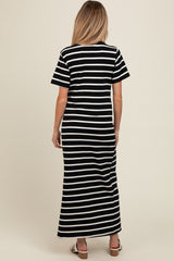 woman wearing a black and white striped maternity maxi dress, shown from the back