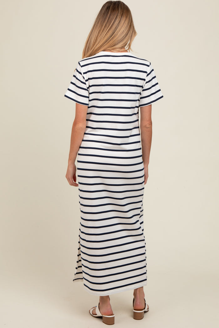 woman wearing a white and navy striped maternity maxi dress with short sleeves and a side slit