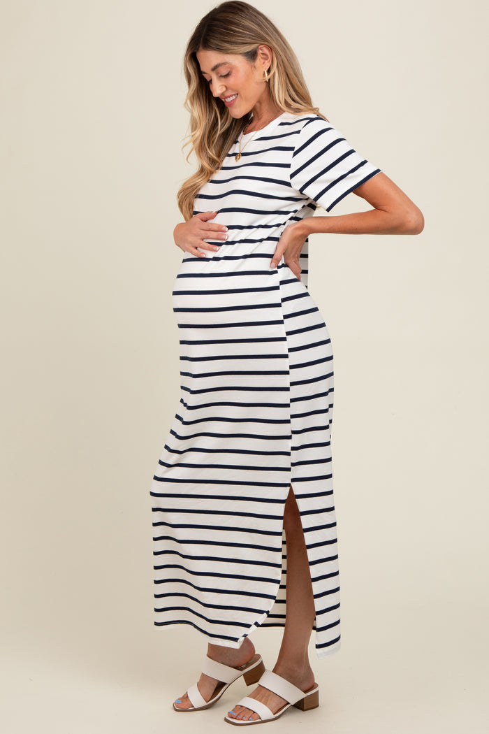 woman wearing a navy and white striped maternity maxi dress, showing her baby bump with side slits and short sleeves