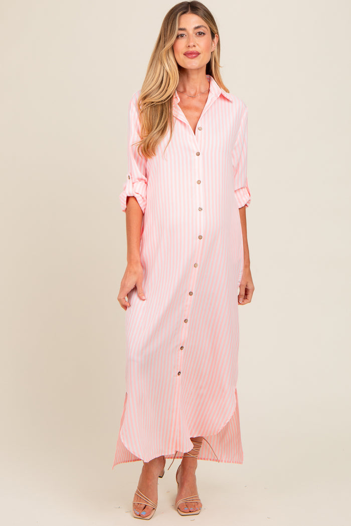 woman wearing a pink and white striped maternity maxi dress with buttons and rolled sleeves, showing her baby bump