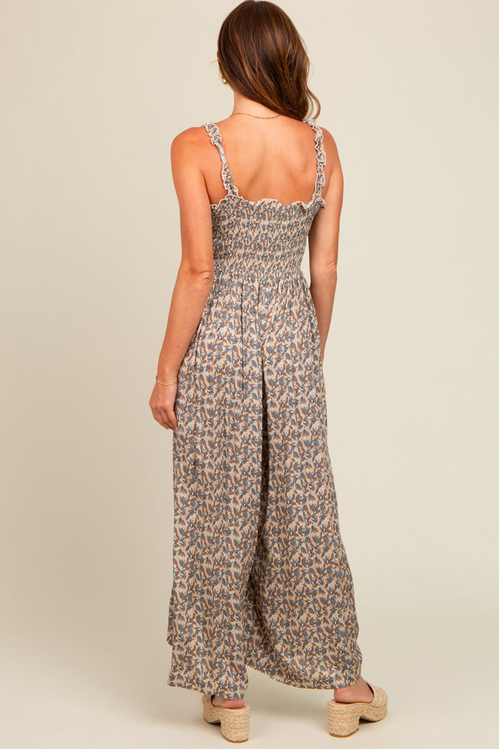 woman wearing a floral backless maxi dress with ruffled straps and a smocked bodice