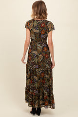woman wearing a floral black maxi dress with short sleeves and ruffle details, viewed from the back