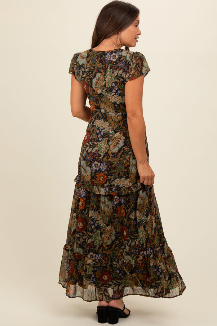 woman wearing a floral patterned maternity maxi dress with short sleeves and a ruffled hem, showing a baby bump from behind