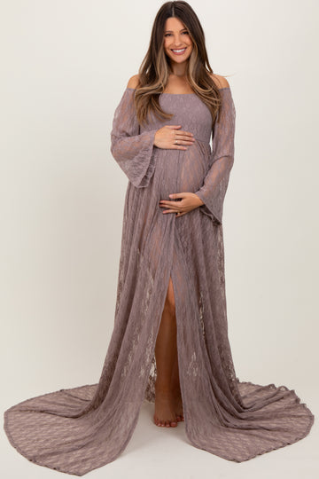 woman wearing a mauve off-the-shoulder lace maternity gown with bell sleeves and a thigh-high slit, holding her baby bump